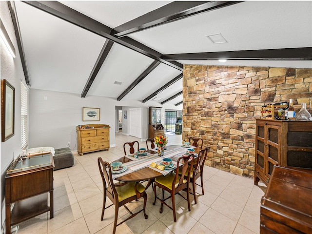 dining space with light tile patterned floors, visible vents, and lofted ceiling with beams