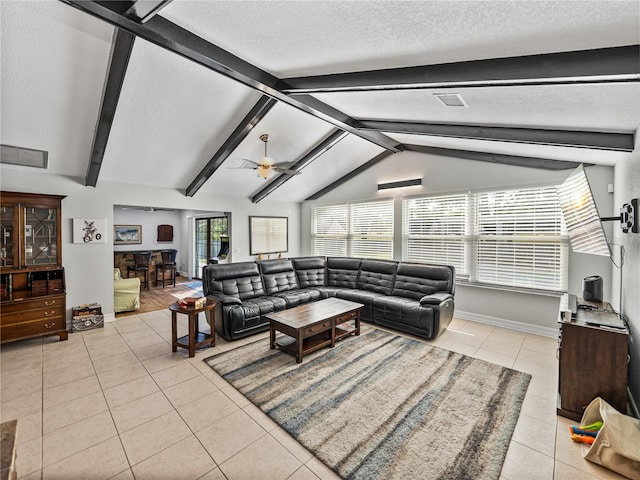 living room with visible vents, light tile patterned flooring, vaulted ceiling with beams, ceiling fan, and a textured ceiling