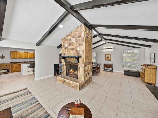 living area with light tile patterned floors, baseboards, lofted ceiling with beams, and a fireplace