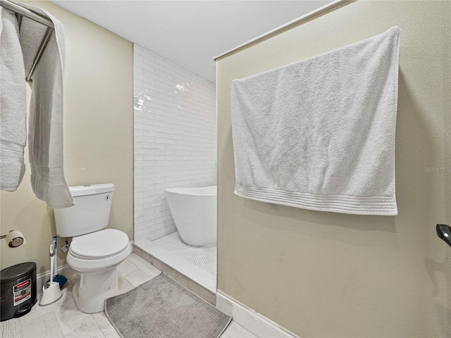 full bathroom featuring baseboards, toilet, and walk in shower