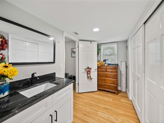 bathroom with visible vents, wood finished floors, and vanity