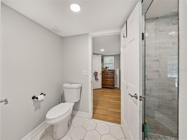 bathroom with visible vents, a shower stall, baseboards, toilet, and tile patterned floors