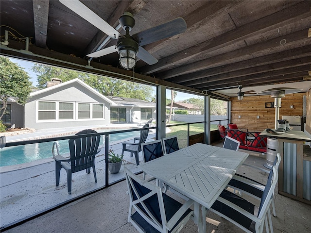 view of patio / terrace with an outdoor pool, outdoor dining area, and a ceiling fan