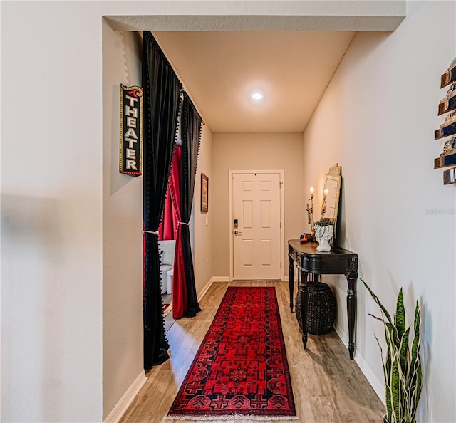 entryway featuring baseboards and light wood finished floors