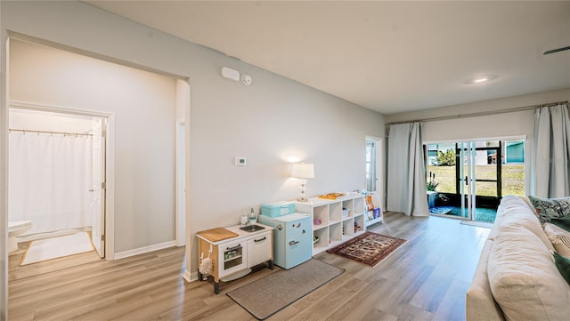 living room featuring light wood-style floors and baseboards