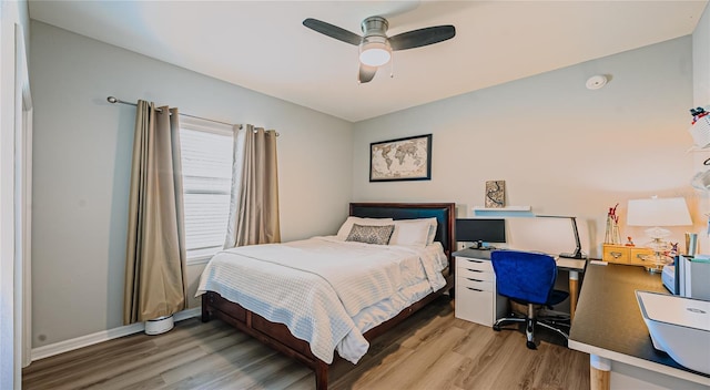 bedroom featuring baseboards, light wood-type flooring, and ceiling fan