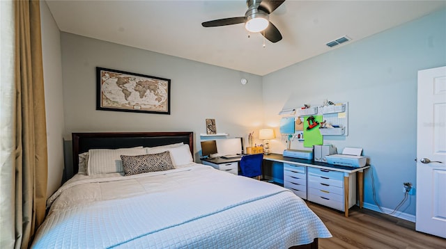 bedroom with visible vents, light wood-style flooring, a ceiling fan, and baseboards