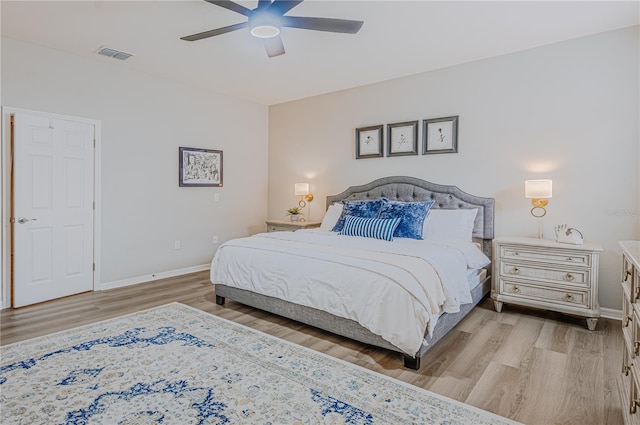 bedroom featuring visible vents, ceiling fan, baseboards, and light wood-style floors