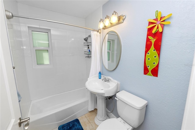 full bath with tile patterned floors, toilet, and shower / bath combo