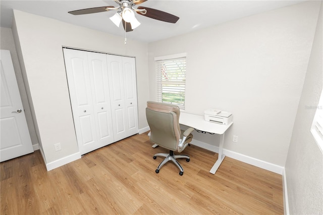 office space featuring light wood-style floors, baseboards, and ceiling fan