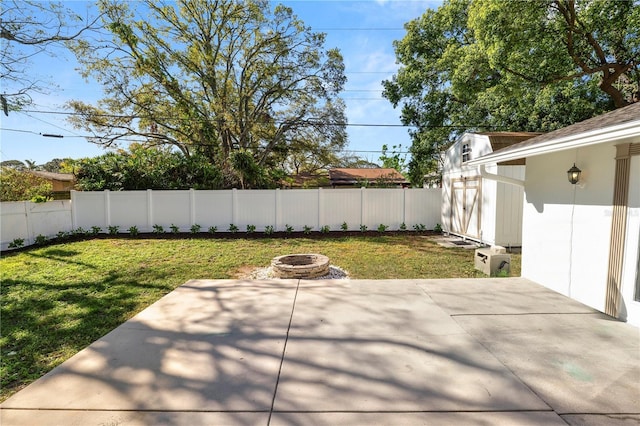 view of patio / terrace featuring a storage unit, an outdoor fire pit, a fenced backyard, and an outdoor structure