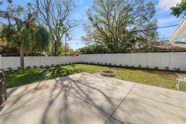 view of patio featuring a fenced backyard and an outdoor fire pit