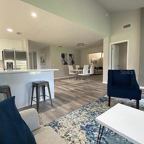 interior space featuring visible vents, recessed lighting, baseboards, and wood finished floors