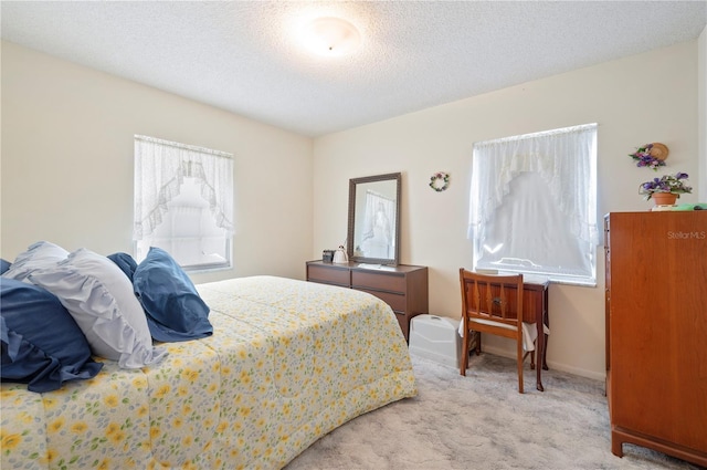 bedroom with carpet flooring, a textured ceiling, and baseboards