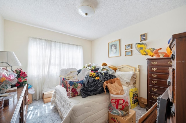 bedroom featuring carpet flooring and a textured ceiling