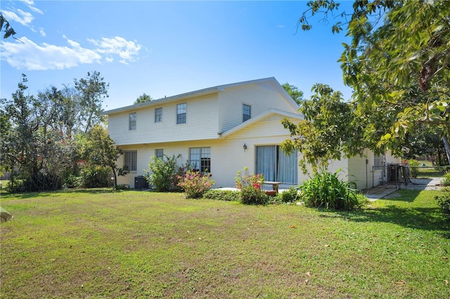 back of property featuring cooling unit, a lawn, and fence