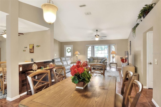 dining room with visible vents, lofted ceiling, and ceiling fan