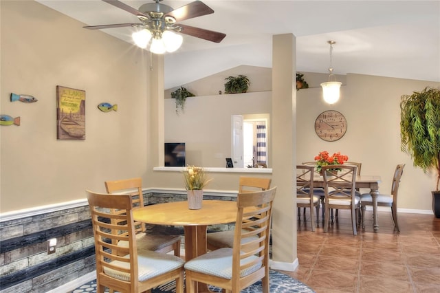 dining room with ceiling fan and vaulted ceiling