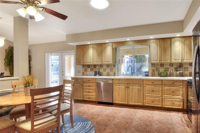 kitchen featuring ceiling fan, a sink, french doors, stainless steel dishwasher, and tasteful backsplash