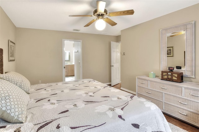 bedroom with a ceiling fan, baseboards, visible vents, and connected bathroom