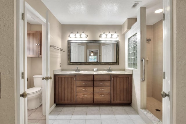 full bathroom with tile patterned flooring, visible vents, a shower stall, and a sink