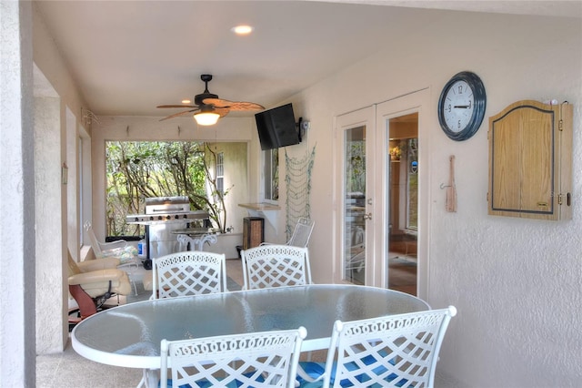 view of patio with outdoor dining space and a ceiling fan