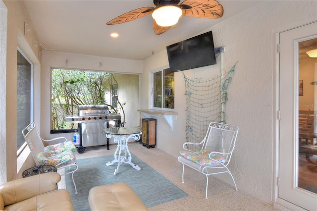 sunroom featuring ceiling fan