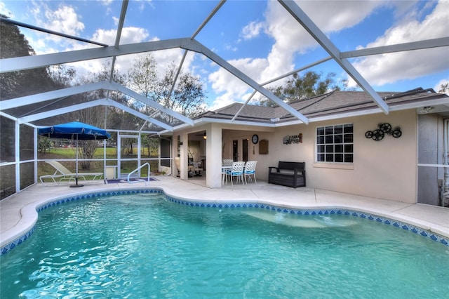 pool with a lanai and a patio area