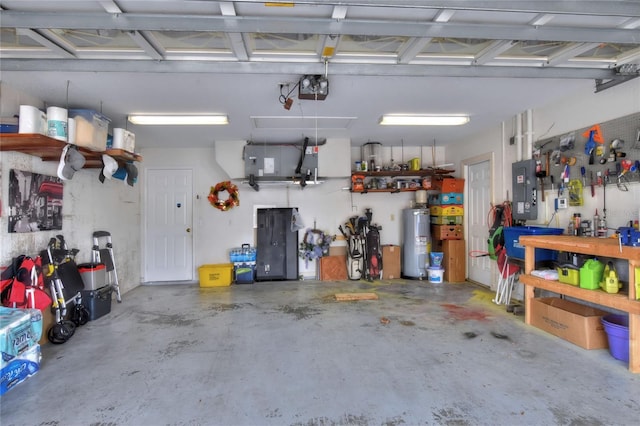 garage featuring a workshop area, electric panel, a garage door opener, and electric water heater