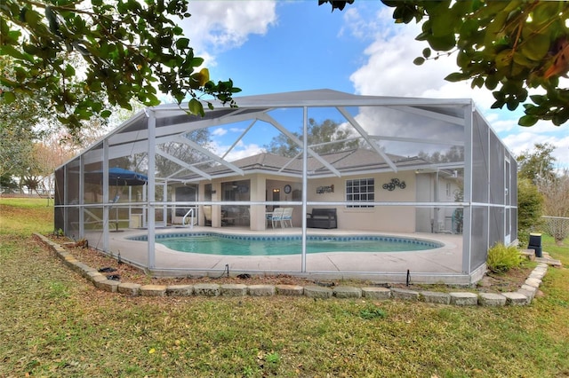 outdoor pool featuring glass enclosure and a patio