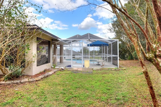 view of yard with an outdoor pool, glass enclosure, and a patio