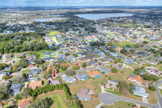 birds eye view of property with a residential view and a water view