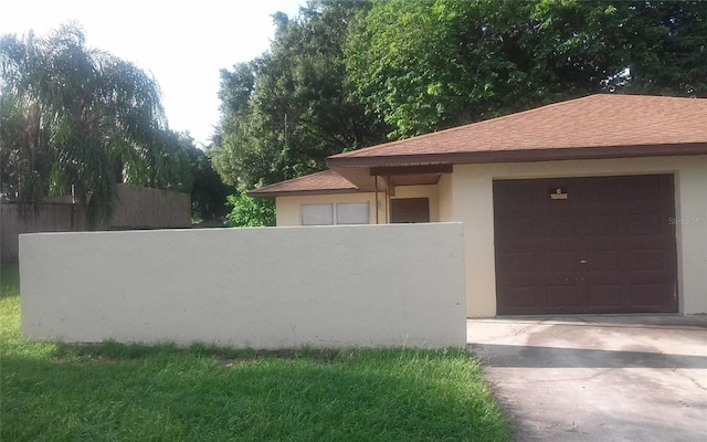 view of front of property featuring fence, a shingled roof, stucco siding, concrete driveway, and a garage