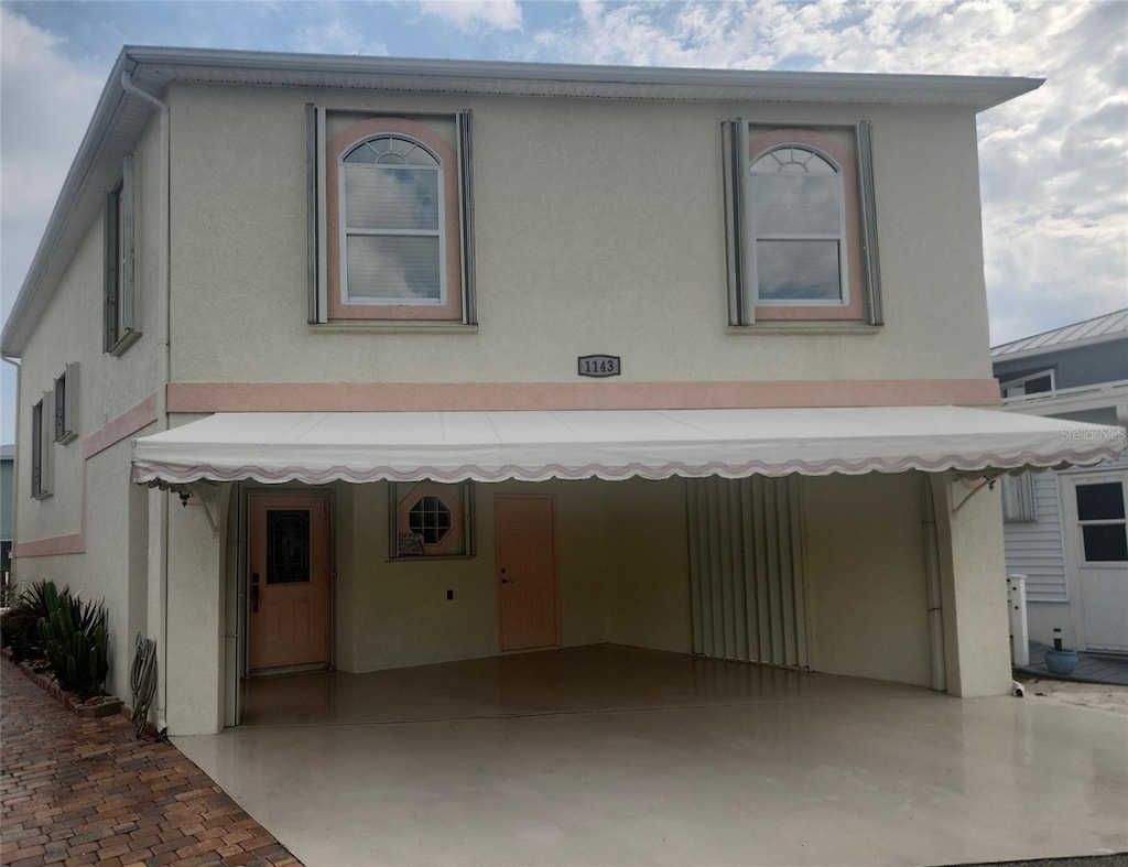 view of front of home with concrete driveway and stucco siding