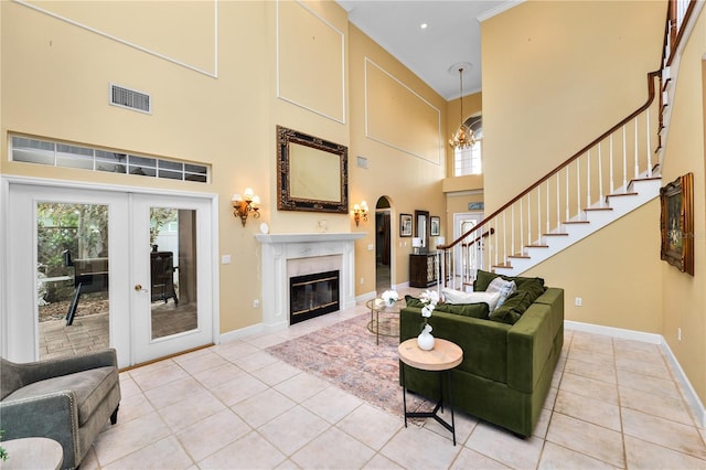 living room with light tile patterned flooring, stairs, baseboards, and a premium fireplace