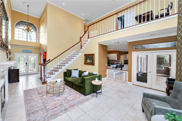 living area with french doors, a chandelier, crown molding, and stairway