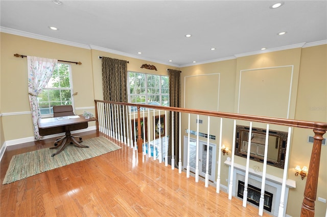 hallway with crown molding, recessed lighting, wood finished floors, and baseboards