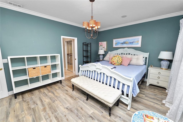 bedroom with wood finished floors, baseboards, visible vents, crown molding, and a chandelier