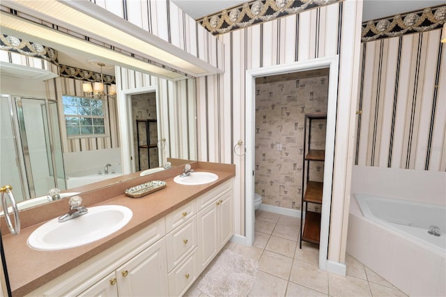 bathroom featuring wallpapered walls, toilet, tile patterned flooring, and a sink