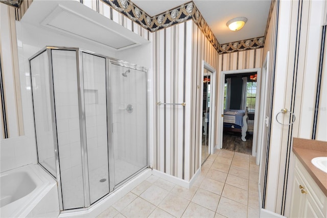 ensuite bathroom featuring a garden tub, a stall shower, wallpapered walls, tile patterned flooring, and vanity