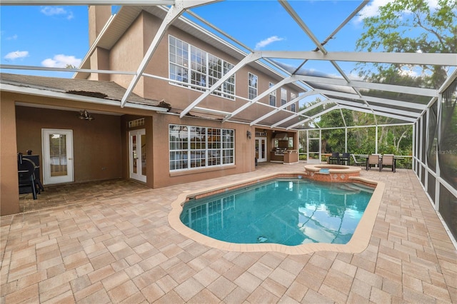 view of swimming pool with a patio, a ceiling fan, a pool with connected hot tub, and a lanai