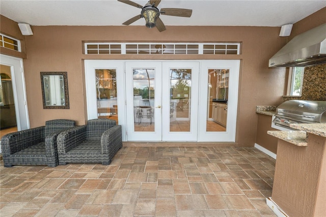 view of exterior entry featuring a patio, area for grilling, french doors, and stucco siding