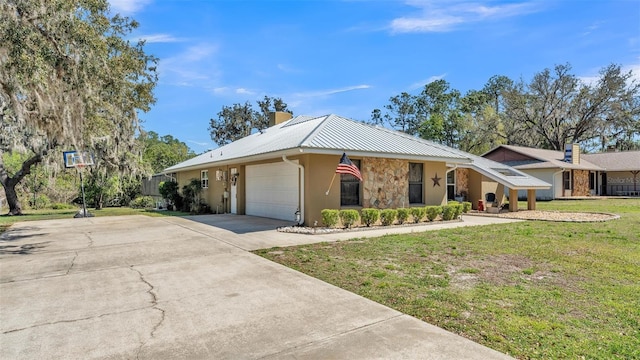 ranch-style house with driveway, a front lawn, stone siding, an attached garage, and metal roof