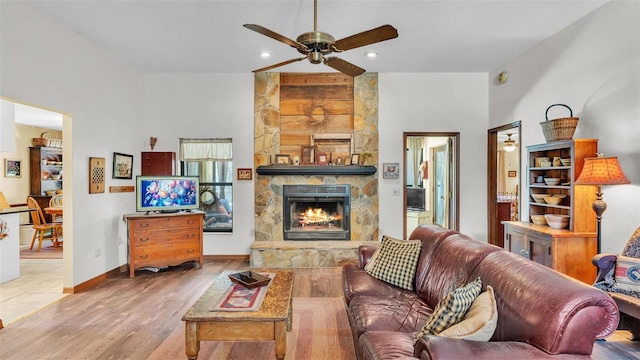 living room with a ceiling fan, wood finished floors, baseboards, recessed lighting, and a fireplace