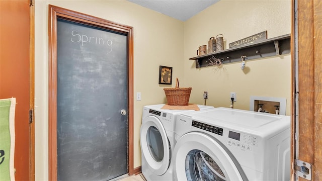 clothes washing area featuring washing machine and dryer and laundry area