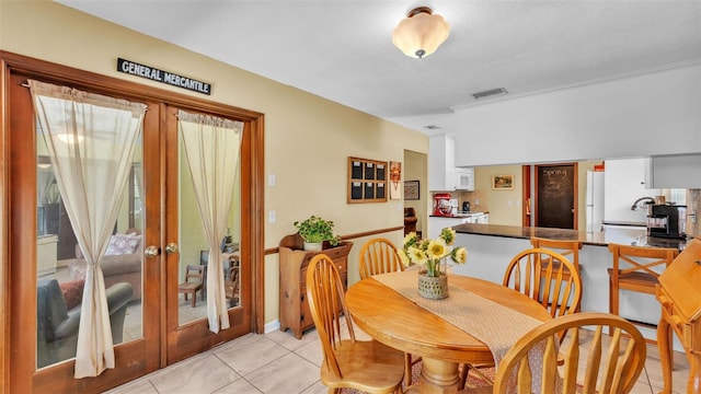 dining room with light tile patterned floors, french doors, and visible vents