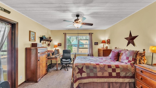 carpeted bedroom with baseboards and a ceiling fan