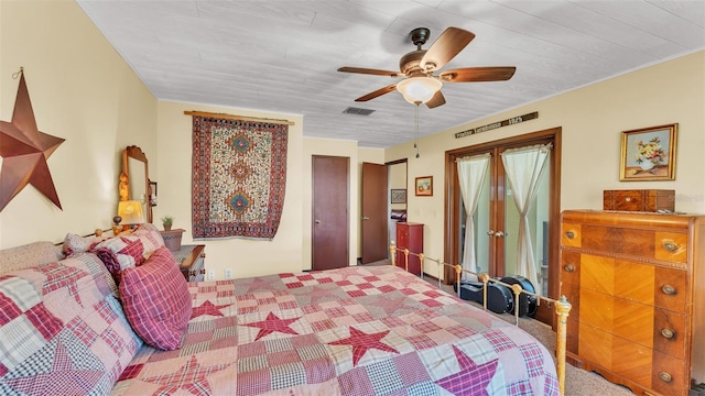 carpeted bedroom featuring visible vents and ceiling fan