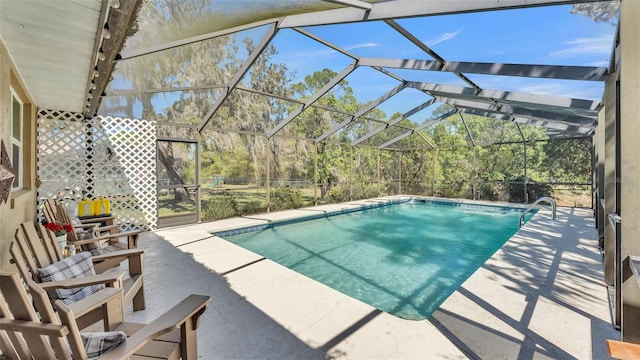 outdoor pool featuring a patio area and glass enclosure