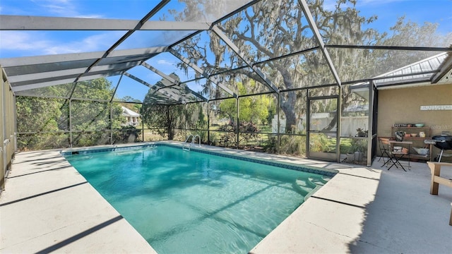 outdoor pool featuring a patio and a lanai